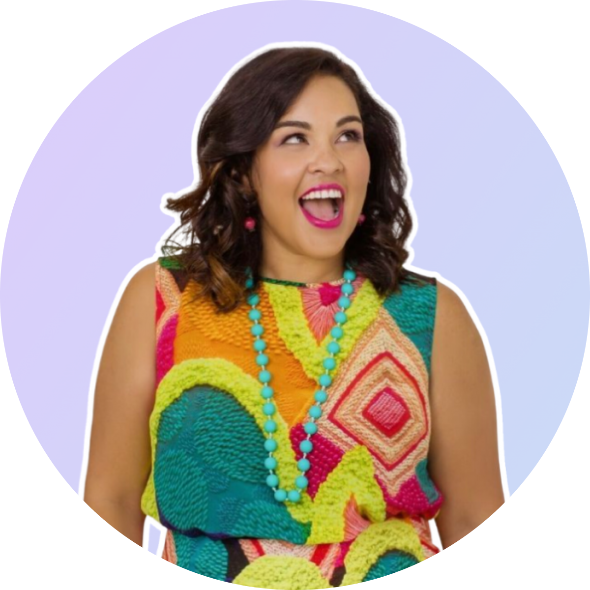 A woman with dark hair, wearing a colorful patterned dress and a turquoise necklace, smiles joyfully against a light purple background, perfect for a social media scheduler post | plannthat.com A woman with dark hair, wearing a colorful patterned dress and a turquoise necklace, smiles joyfully against a light purple background, perfect for a social media scheduler post | plannthat.com